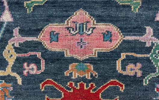 Intricate vintage area rug with colorful geometric floral patterns and distressed finish.