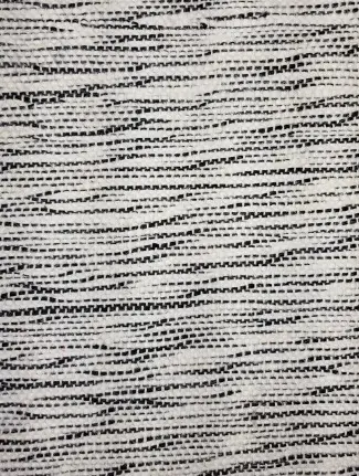 Textured black and white patterned flooring sample.