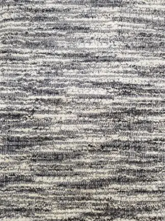 Textured grey and black carpet with modern pattern for residential and commercial flooring solutions.
