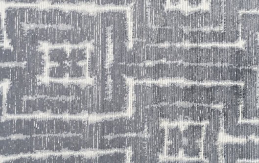 Intricate grey and white patterned carpet with modern geometric design.
