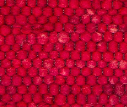 Vivid red carpet texture with woven pattern, perfect for flooring and decorative surfaces.