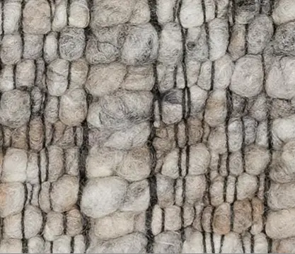 Weathered stone wall with natural texture and earthy tones suitable for rustic interior design.