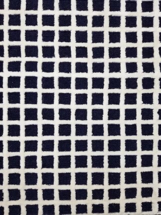 Close-up of textured geometric patterned flooring in black and white, ideal for modern interior design.