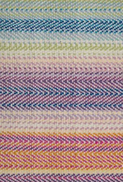 Vibrant woven rug with colorful geometric patterns, perfect for enhancing home flooring and interior design.