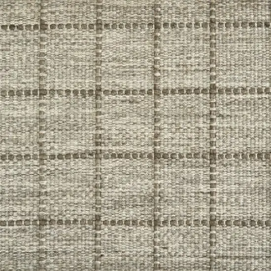 Cream and beige checkered patterned carpet flooring for modern interior design.
