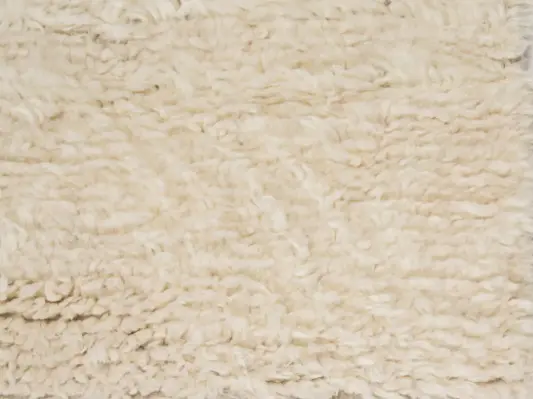 Plush cream shag carpet with durable, cozy texture for residential and commercial flooring solutions.