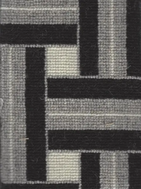 Black and gray geometric patterned carpet for modern interior flooring.