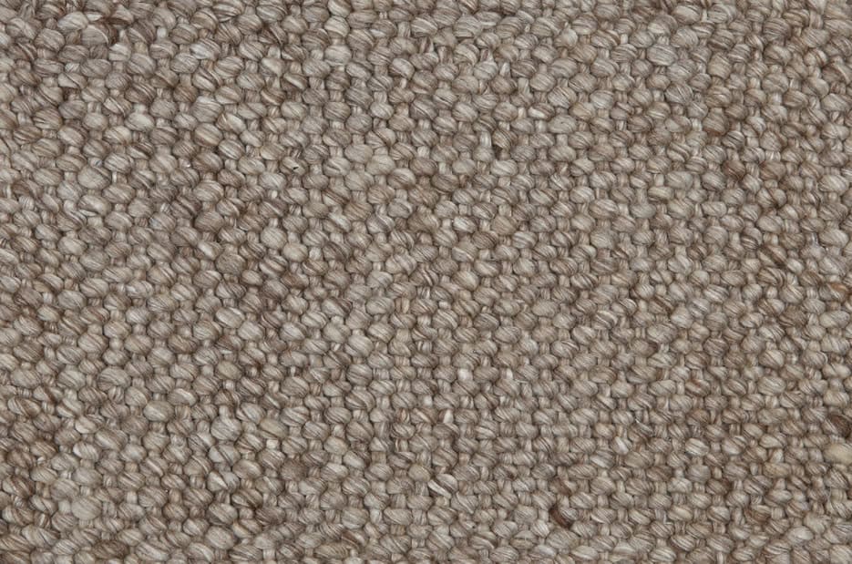 Cream beige textured carpet with tightly woven loops, ideal for home or office flooring.