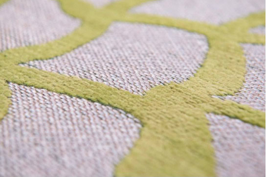 Elegant green and beige patterned carpet with soft texture, ideal for stylish interior flooring.