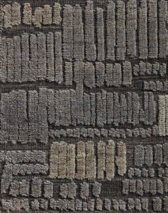 Soft gray textured carpet with geometric pattern, ideal for modern interior flooring.