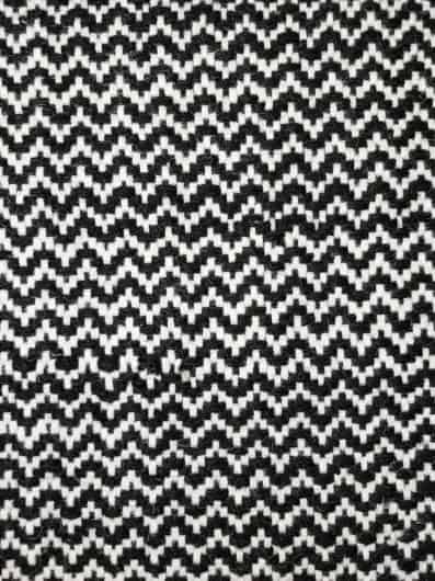 Black and white zigzag patterned carpet for modern interior flooring.