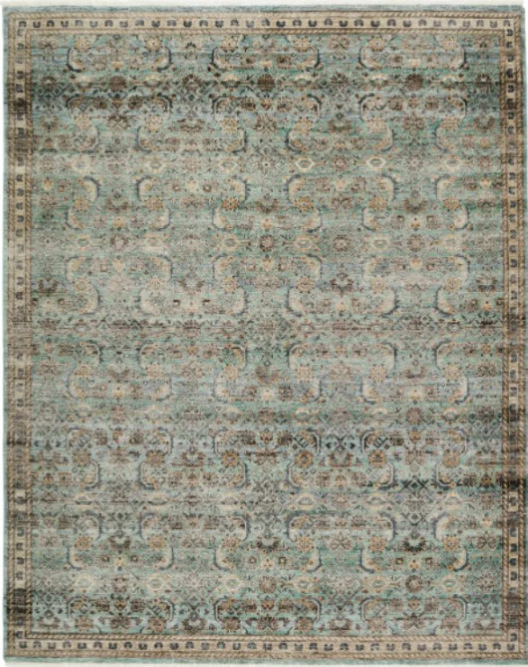 Vintage distressed area rug with intricate traditional patterns in muted blue, beige, and ivory tones.
