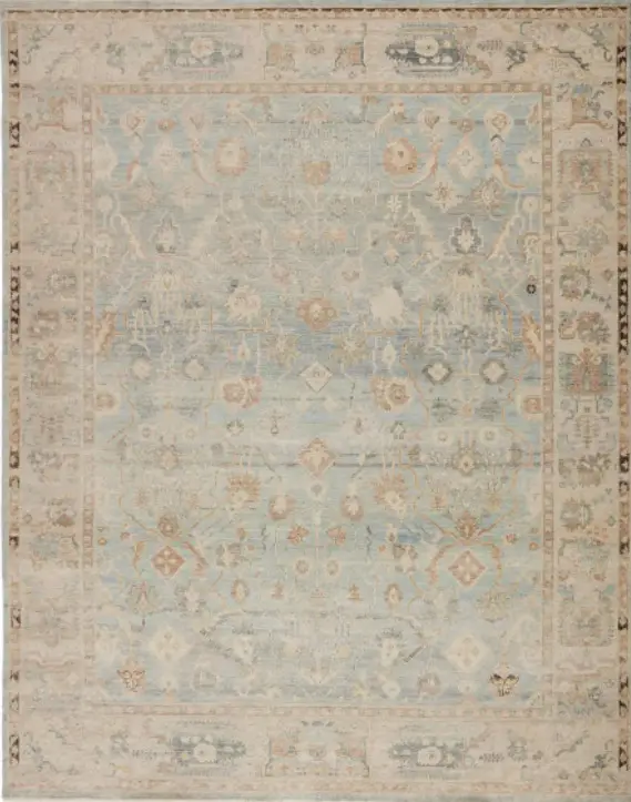 Vintage distressed area rug with intricate floral pattern, soft pastel colors, suited for elegant home decor.