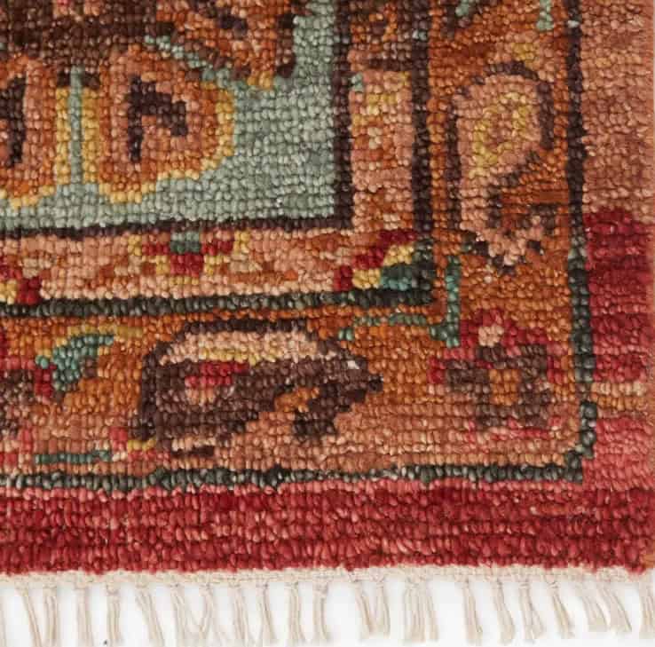 Vintage Persian rug with intricate floral design and vibrant colors.