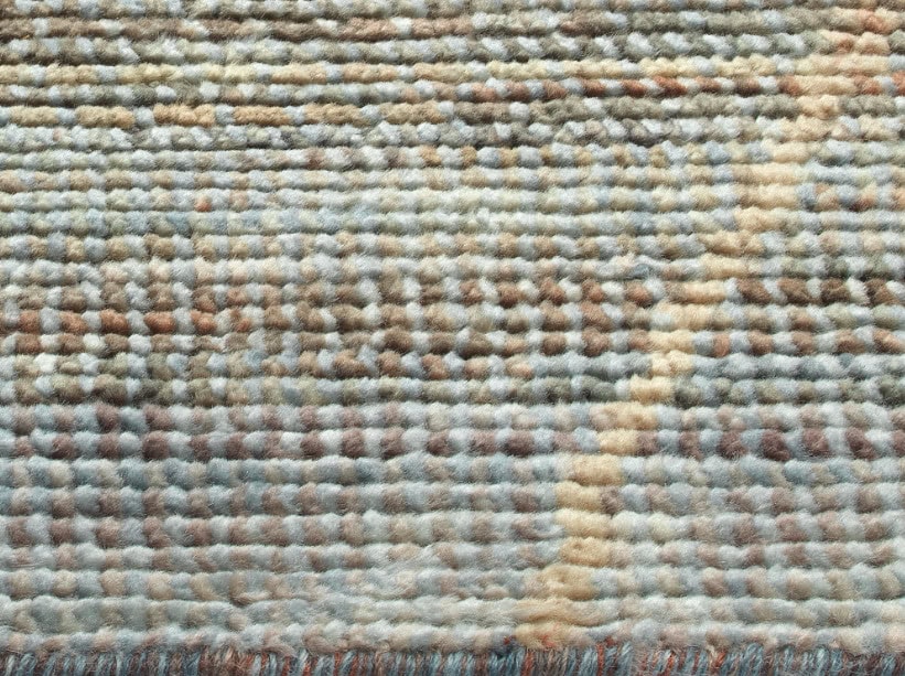 Soft textured carpet with neutral beige and light brown tones, ideal for residential and commercial flooring.