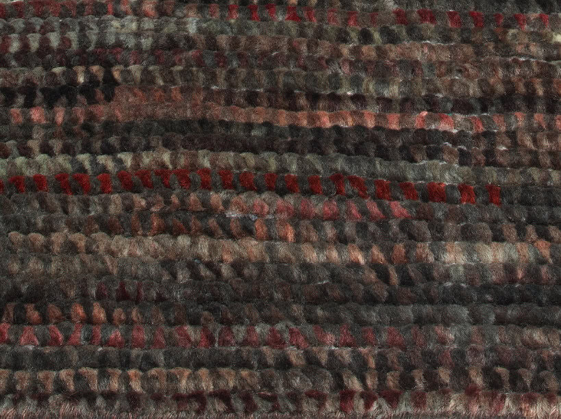 Rich textured carpet with multi-tone earthy colors and red accents for home or commercial flooring.