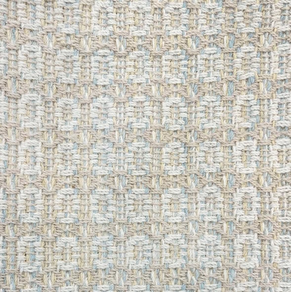 Soft textured beige and blue woven carpet, ideal for modern interiors.