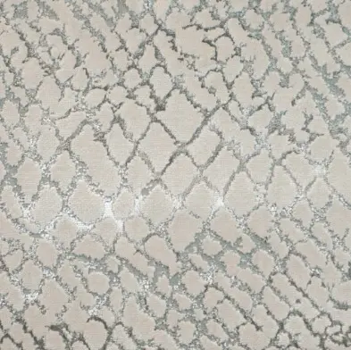 Soft beige and gray patterned area rug with geometric design for modern living spaces.