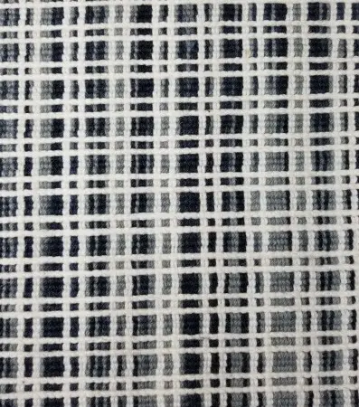Textile flooring pattern with geometric black and white grid design.