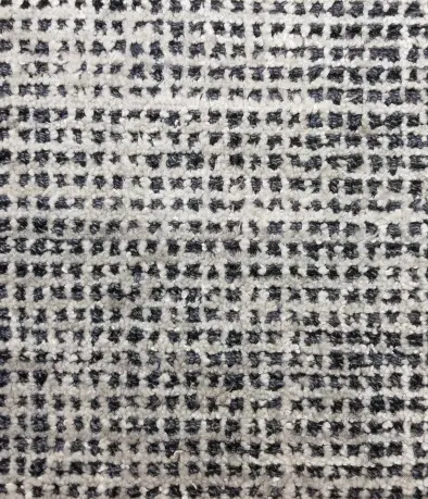 Soft black and white woven carpet textile close-up.