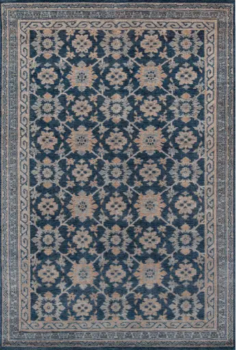 Luxurious navy and beige patterned area rug with floral design.