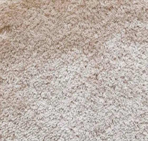 Fluffy beige carpet with plush texture, ideal for home flooring and interior design.