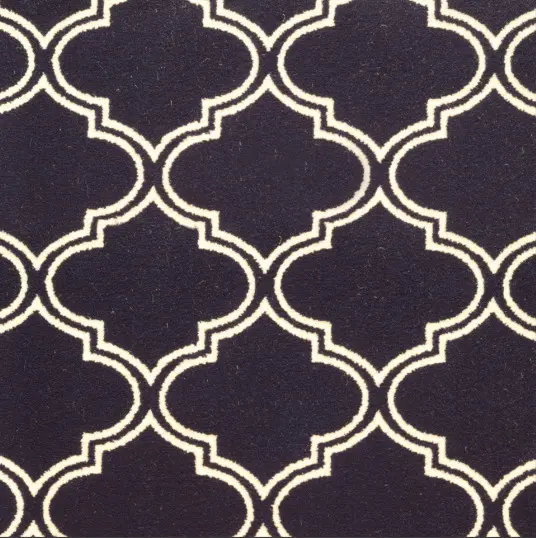 Stylish black and white geometric patterned area rug for interior decor.