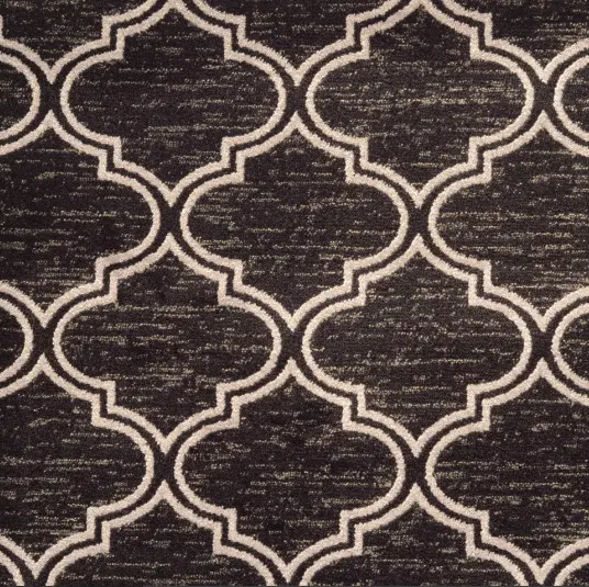 Patterned black and white area rug with geometric design for living room decor.