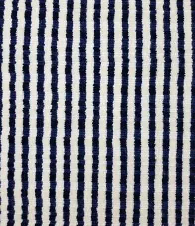 Vibrant striped area rug with navy and cream pattern for modern flooring designs.