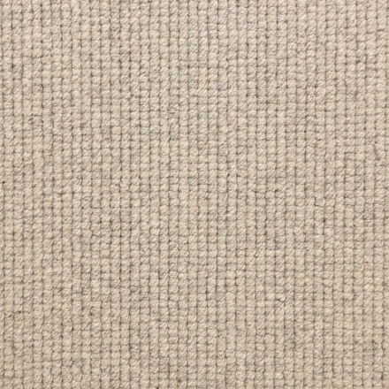 Soft beige textured carpet for stylish and durable flooring in residential or commercial spaces.
