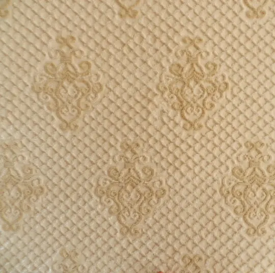Cream textured carpet with intricate pattern, ideal for luxury flooring solutions.