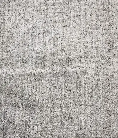 Muted gray textured carpet for stylish, durable flooring in residential and commercial spaces.