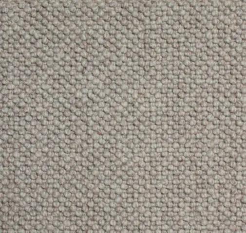 Soft beige carpet with textured loop pile, ideal for home or office flooring.