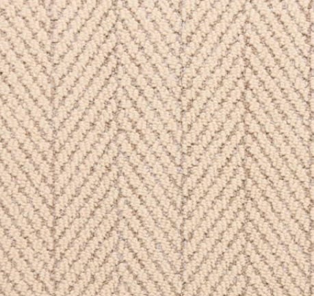 Soft beige herringbone carpet featuring textured wool style flooring.