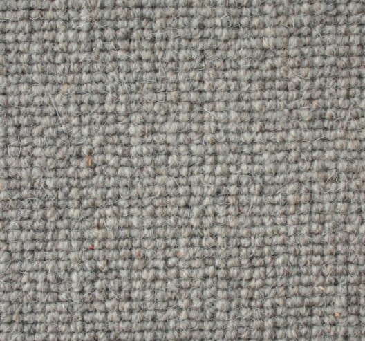 Soft beige carpet with textured woven pattern, ideal for residential and commercial flooring solutions.