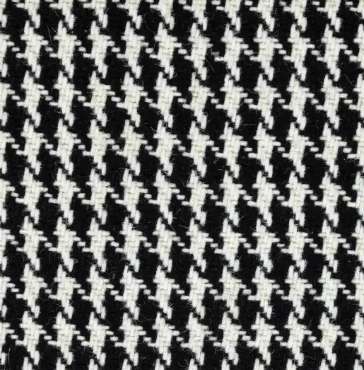 Houndstooth patterned carpet featuring black and white geometric design.