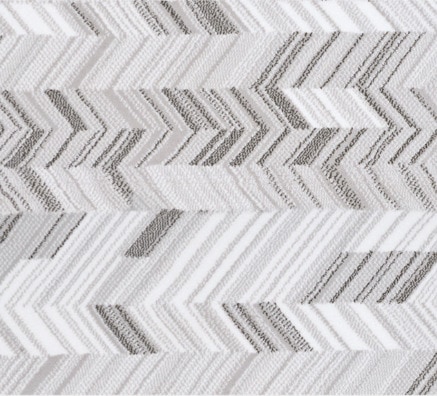 Soft gray and white chevron-patterned area rug for modern interior decor.