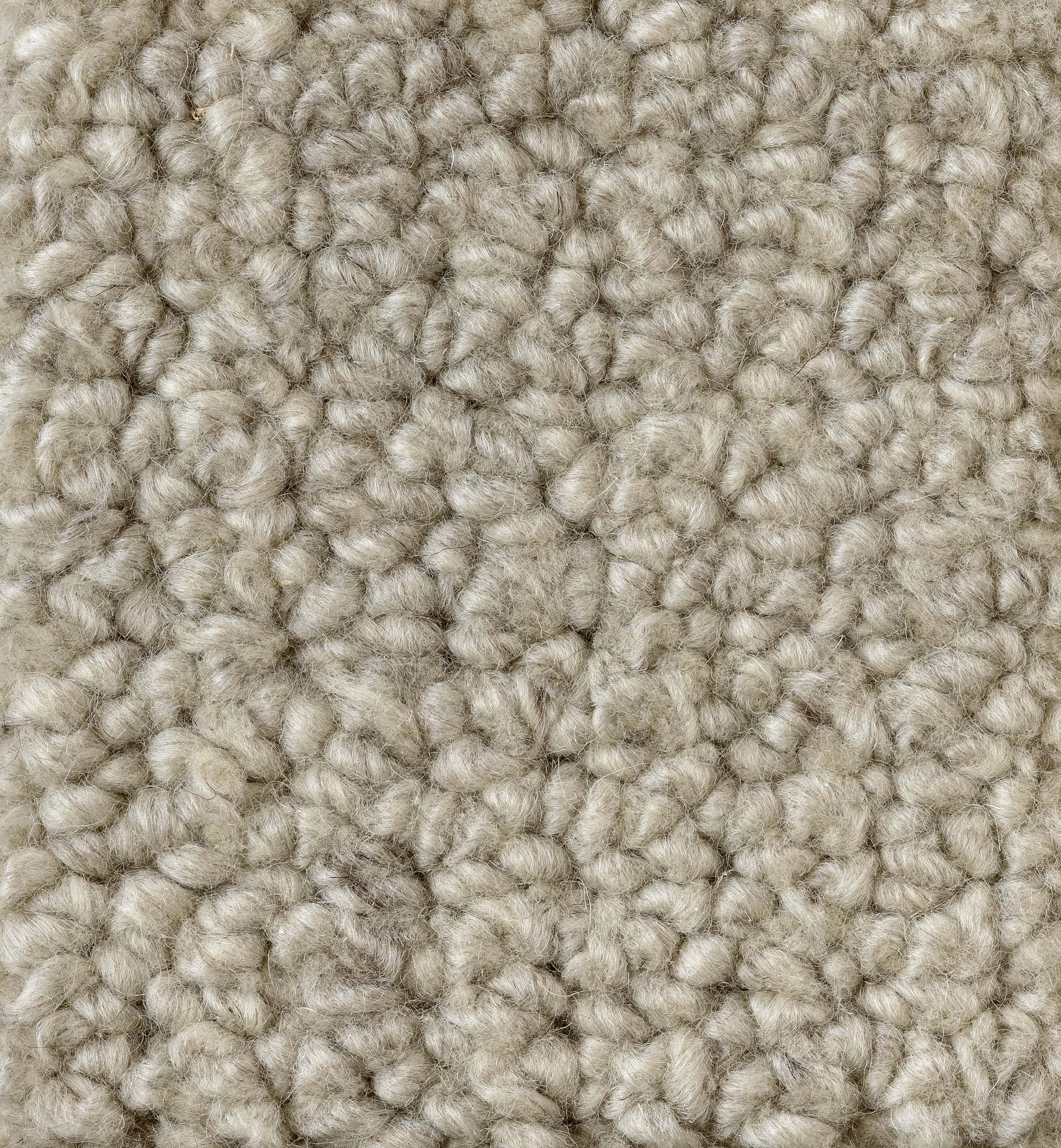 Luxurious beige textured carpet with soft, plush fibers for home comfort.