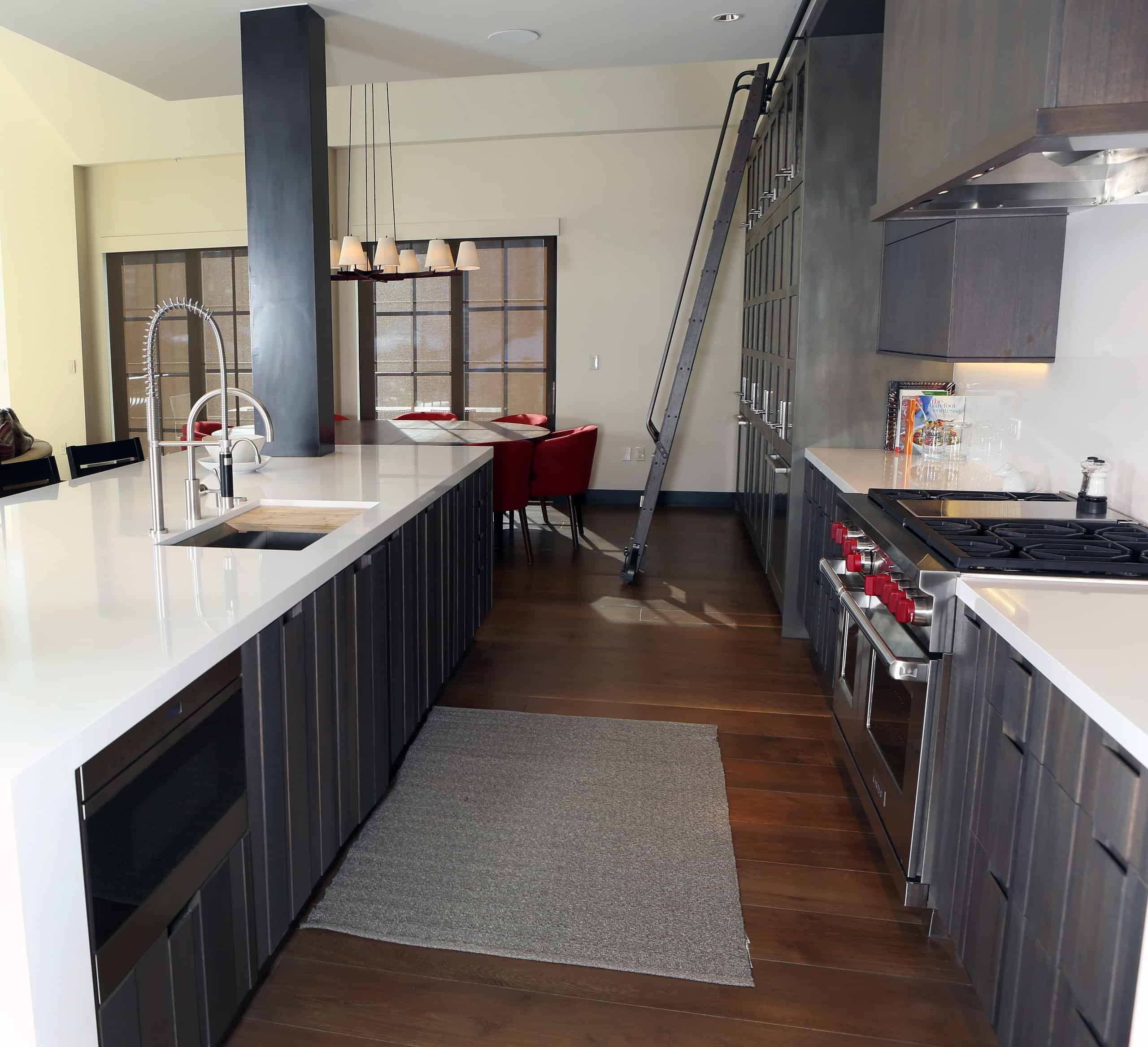 Silestone white quartz countertop in modern kitchen with dark wood cabinets.