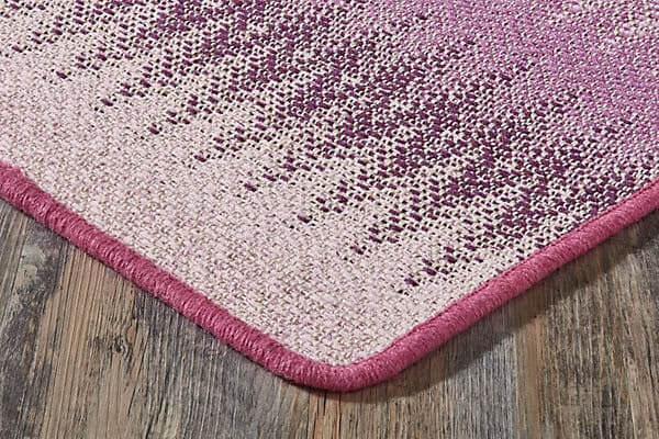 Soft pink modern area rug with textured pattern, ideal for contemporary home decor.