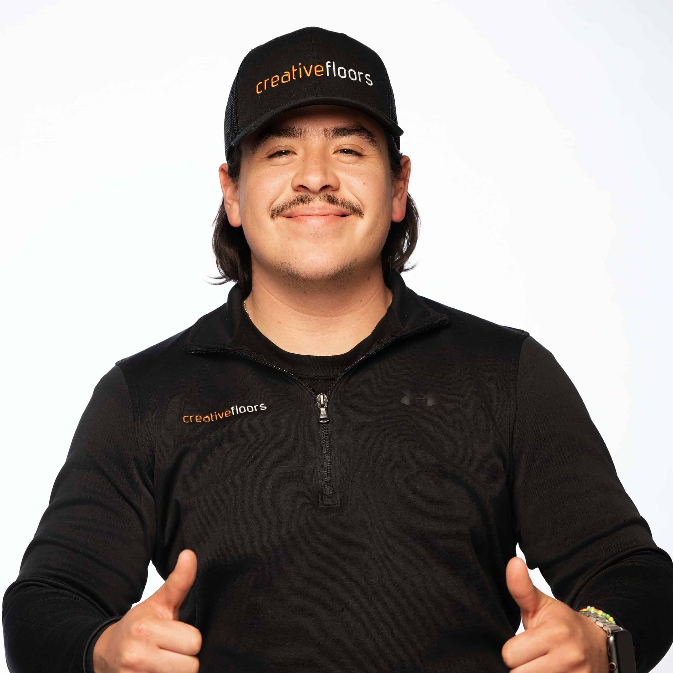 Creative floors professional flooring expert man smiling and giving thumbs up.