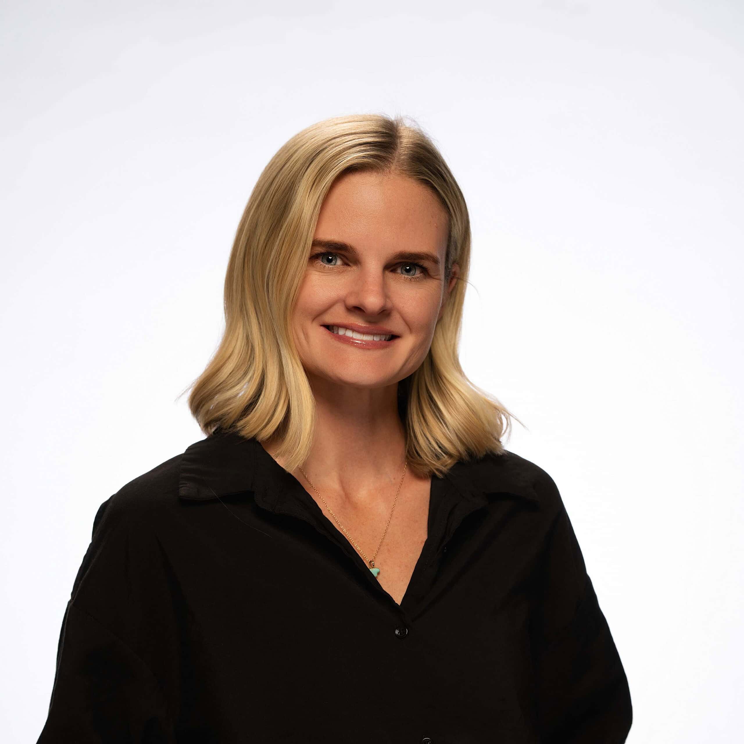 Flooring contractor headshot, professional woman in black shirt for flooring business.