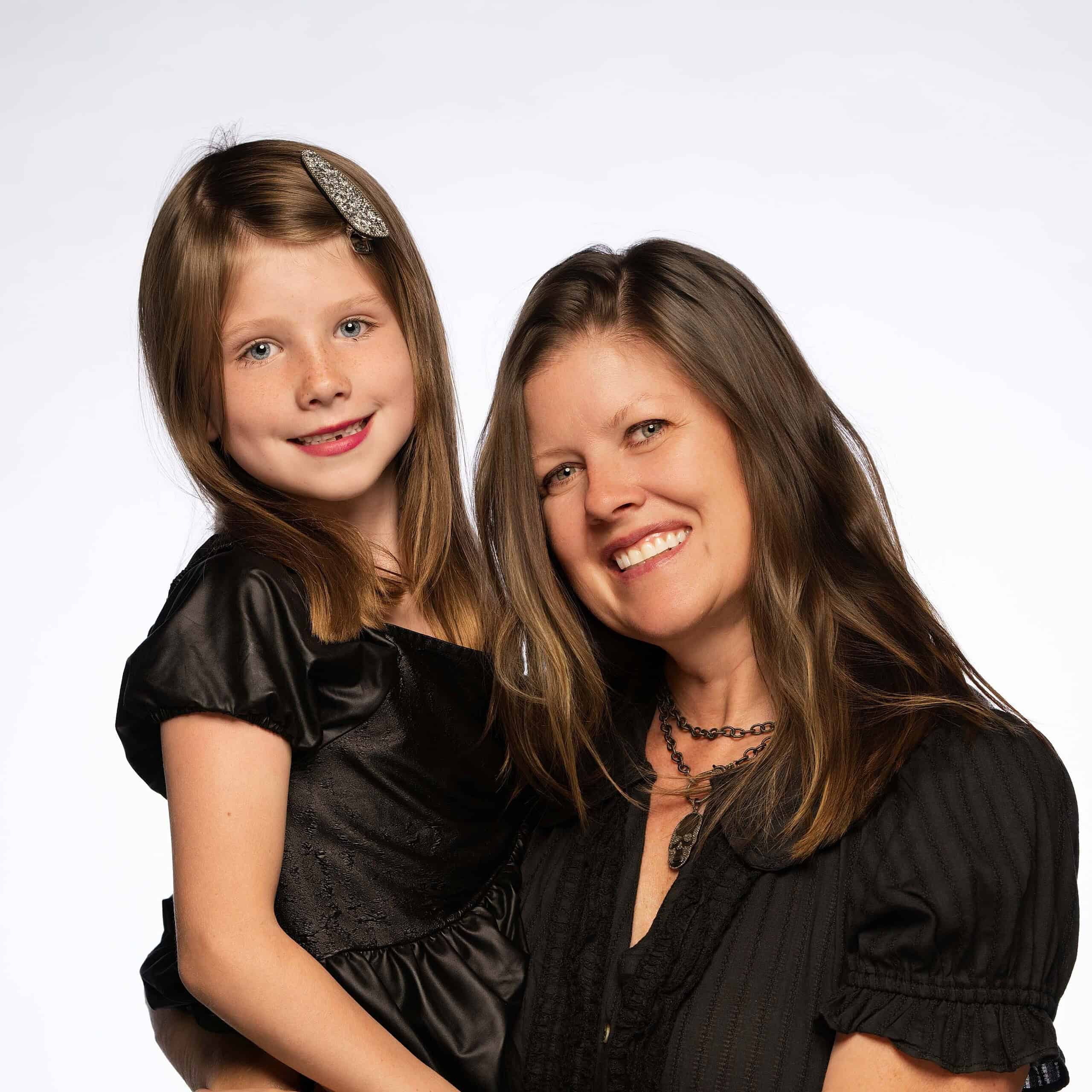 Creative Floors family portrait featuring a smiling woman and young girl with brown hair, showcasing home flooring solutions.