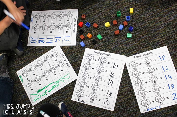 Four completed Turkey Doubles worksheets on the classroom carpet