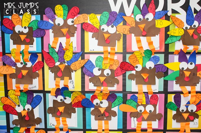 A bulletin board with many colorful paper turkey crafts