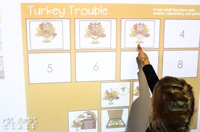 A child is dragging and dropping an image onto a digital activity