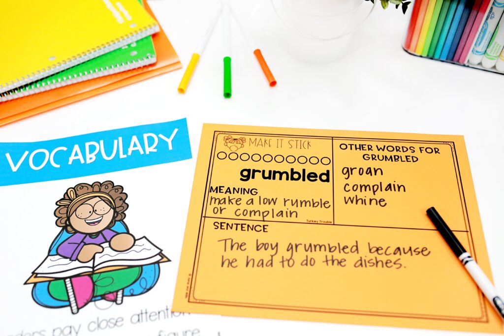 An orange vocabulary card for the word "grumbled"