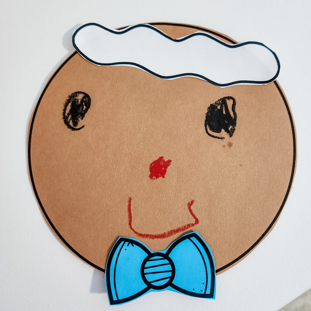 Gingerbread man head with a blue bow tie