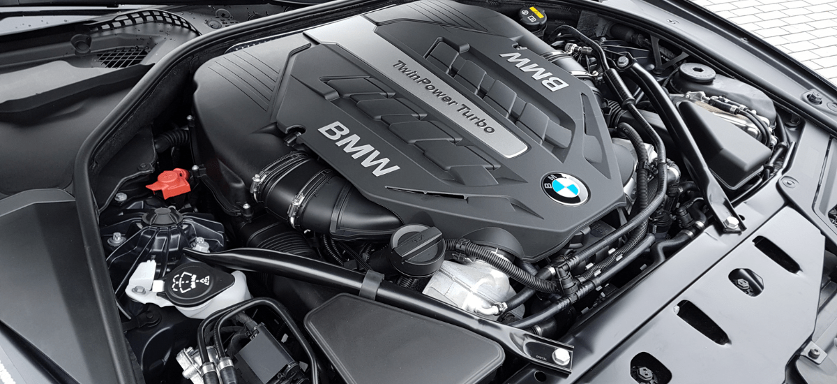 Close-up of BMW turbo engine showing detailed components and engine cover.