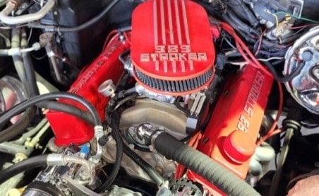 Close-up of a powerful red engine with "888 Stroker" label, showcasing automotive performance and re.
